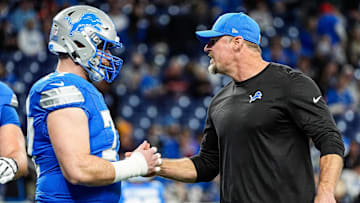 Detroit Lions head coach Dan Campbell shakes hands with center Frank Ragnow (77) warm up before the game between Detroit Lions and Chicago Bears at Ford Field in Detroit on Thursday, Nov. 28, 2024.