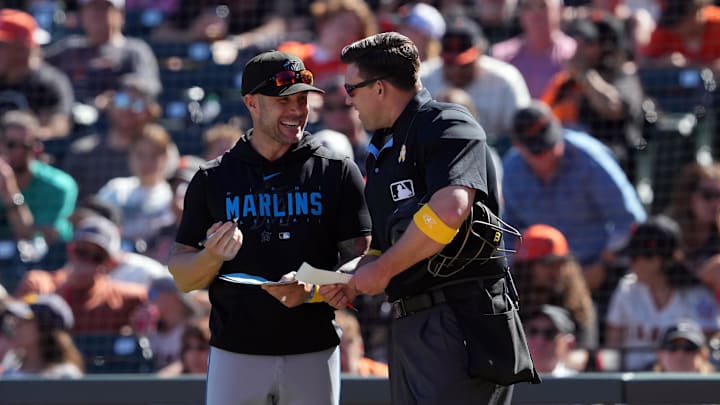 Miami Marlins manager Skip Schumaker (left) talks with home plate umpire Jacob Metz (94) during the ninth inning against the San Francisco Giants at Oracle Park on Sept 1.