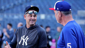 New York Yankees manager Aaron Boone talks to Texas Rangers manager Bruce Bochy before a game at Yankee Stadium.