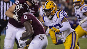 Nov 26, 2022; College Station, Texas, USA; Texas A&M Aggies running back Devon Achane (6) and LSU Tigers linebacker Micah Baskerville (23) in action during the game between the Texas A&M Aggies and the LSU Tigers at Kyle Field. Mandatory Credit: Jerome Miron-Imagn Images