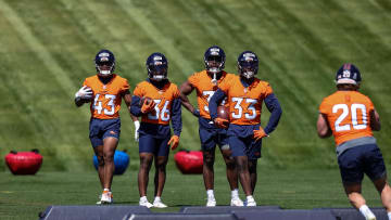 May 23, 2024; Englewood, CO, USA; Denver Broncos running back Blake Watson (43) and running back Tyler Badie (36) and running back Audric Estime (37) and running back Javonte Williams (33) look on as full back Michael Burton (20) runs a drill during organized team activities at Centura Health Training Center. Mandatory Credit: Isaiah J. Downing-USA TODAY Sports