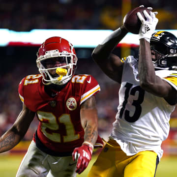 Jan 16, 2022; Kansas City, Missouri, USA; Pittsburgh Steelers wide receiver James Washington (13) catches a touchdown while defended by Kansas City Chiefs cornerback Mike Hughes (21) in an AFC Wild Card playoff football game at GEHA Field at Arrowhead Stadium. Mandatory Credit: Jay Biggerstaff-USA TODAY Sports