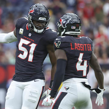 Nov 24, 2024; Houston, Texas, USA; Houston Texans defensive end Will Anderson Jr. (51) celebrate with cornerback Kamari Lassiter (4) after a tackle during the first quarter against the Tennessee Titans at NRG Stadium. Mandatory Credit: Troy Taormina-Imagn Images