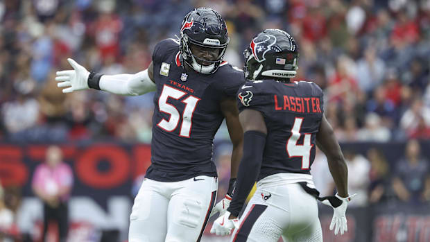 Houston Texans defensive end Will Anderson Jr. (51) celebrate with cornerback Kamari Lassiter (4) after a tackle