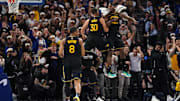 Stephen Curry is congratulated by guard Buddy Hield after making a three-point basket.