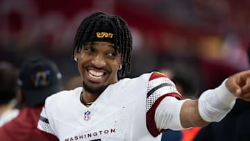 Sep 29, 2024; Glendale, Arizona, USA; Washington Commanders quarterback Jayden Daniels (5) celebrates against the Arizona Cardinals at State Farm Stadium. Mandatory Credit: Mark J. Rebilas-Imagn Images