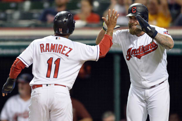 Jose Ramirez and Mike Napoli celebrate after scoring a run 