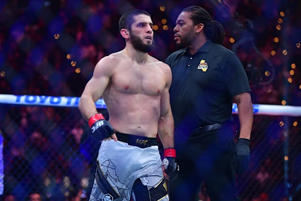 Islam Makhachev (red gloves) reacts after defeating Renato Moicano (blue gloves) in a lightweight title fight. 