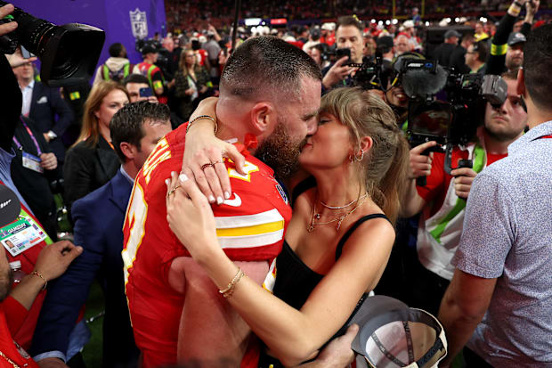 Travis Kelce #87 of the Kansas City Chiefs and Taylor Swift embrace after defeating the San Francisco 49ers in overtime durin