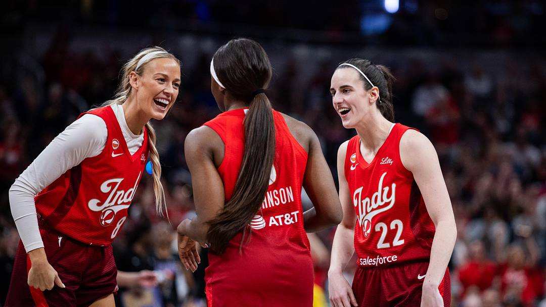 May 22, 2026; Indianapolis, Indiana, USA;  Indiana Fever guard Caitlin Clark (22) and  guard Sophie Cunningham (8) celebrate a made shot with  guard Raven Johnson (3) in the second half against the Golden State Valkyries at Gainbridge Fieldhouse. Mandatory Credit: Trevor Ruszkowski-Imagn Images