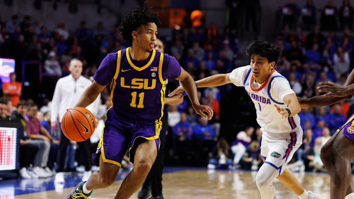 Jan 20, 2026; Gainesville, Florida, USA; Louisiana State Tigers guard Dedan Thomas Jr. (11) drives to the basket past Florida Gators guard Xaivian Lee (1) during the first half at Exactech Arena at the Stephen C. O'Connell Center. Mandatory Credit: Matt Pendleton-Imagn Images