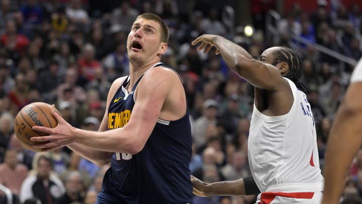 Apr 4, 2024; Los Angeles, California, USA; Denver Nuggets center Nikola Jokic (15) drives past Los Angeles Clippers guard James Harden (1) in the second half at Crypto.com Arena. Mandatory Credit: Jayne Kamin-Oncea-USA TODAY Sports