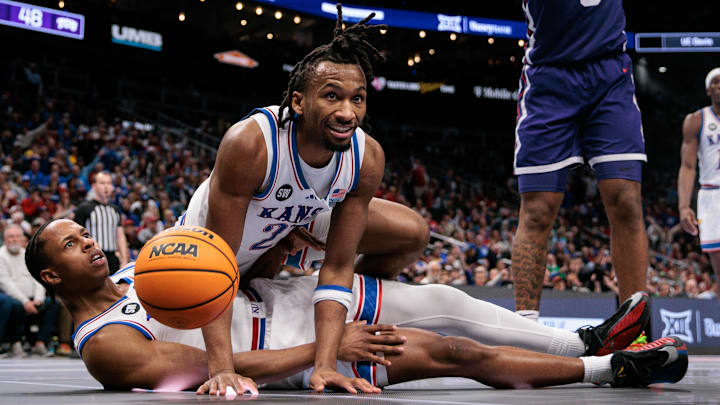 Mar 12, 2026; Kansas City, MO, USA; Kansas basketball guard Elmarko Jackson (13) and guard Darryn Peterson (22) get tangled up during the second half against the TCU Horned Frogs at T-Mobile Center. Mandatory Credit: William Purnell-Imagn Images