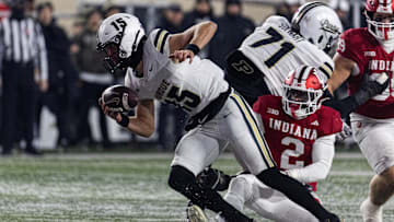 Nov 30, 2024; Bloomington, Indiana, USA; Purdue Boilermakers quarterback Ryan Browne (15) runs the ball while Indiana Hoosiers linebacker Jailin Walker (2) defends in the second half at Memorial Stadium. Mandatory Credit: Trevor Ruszkowski-Imagn Images