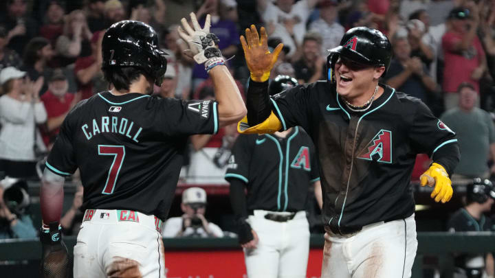 Aug 14, 2024; Phoenix, Arizona, USA; Arizona Diamondbacks designated hitter Joc Pederson (right) celebrates with outfielder Corbin Carroll (7) after scoring a run on a throwing error against the Colorado Rockies in the first inning at Chase Field. Mandatory Credit: Rick Scuteri-USA TODAY Sports