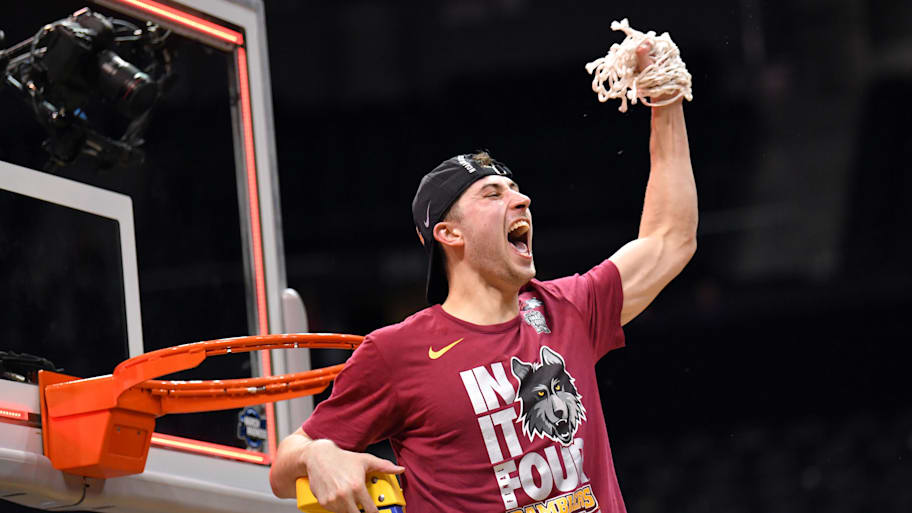 Loyola Ramblers guard Ben Richardson cuts the net after defeating the Kansas State Wildcats to reach the Final Four.