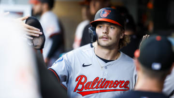 Jul 2, 2024; Seattle, Washington, USA; Baltimore Orioles shortstop Gunnar Henderson (2) high-fives teammates in the dugout after scoring a run against the Seattle Mariners during the fourth inning at T-Mobile Park.
