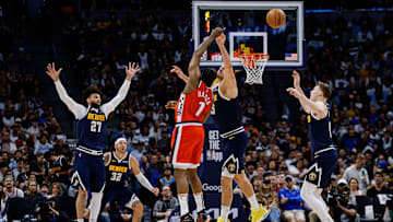 Los Angeles Clippers guard Amir Coffey (7) passes the ball as Denver Nuggets center Nikola Jokic (15) and guard Jamal Murray (27) and guard Christian Braun (0) defend in the third quarter during game two of first round for the 2025 NBA Playoffs at Ball Arena. Mandatory Credit: Isaiah J. Downing-Imagn Images