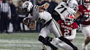 Purdue Boilermakers quarterback Ryan Browne (15) runs the ball while Indiana Hoosiers linebacker Jailin Walker (2) defends