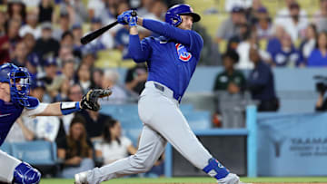 Sep 11, 2024; Los Angeles, California, USA;  Chicago Cubs first baseman Michael Busch (29) hits an RBI double during the first inning against the Los Angeles Dodgers at Dodger Stadium. 