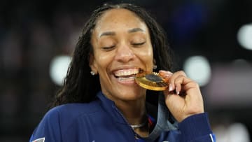 South Carolina Gamecocks legend A'ja Wilson posing with her latest Olympic gold medal