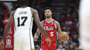 Mar 17, 2025; Houston, Texas, USA; Philadelphia 76ers guard Quentin Grimes (5) brings the ball up the court as Houston Rockets forward Tari Eason (17) defends during the fourth quarter at Toyota Center. Mandatory Credit: Troy Taormina-Imagn Images