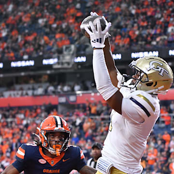 Sep 7, 2024; Syracuse, New York, USA; Georgia Tech Yellow Jackets wide receiver Chase Lane (7) catches a touchdown pass as Syracuse Orange defensive back Clarence Lewis (3) defends in the fourth quarter at the JMA Wireless Dome. Mandatory Credit: Mark Konezny-Imagn Images