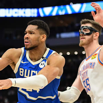 Mar 16, 2025; Milwaukee, Wisconsin, USA; Milwaukee Bucks forward Giannis Antetokounmpo (34) passes the ball away from Oklahoma City Thunder center Isaiah Hartenstein (55) in the fourth quarter at Fiserv Forum. Mandatory Credit: Benny Sieu-Imagn Images