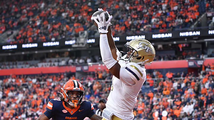 Sep 7, 2024; Syracuse, New York, USA; Georgia Tech Yellow Jackets wide receiver Chase Lane (7) catches a touchdown pass as Syracuse Orange defensive back Clarence Lewis (3) defends in the fourth quarter at the JMA Wireless Dome. Mandatory Credit: Mark Konezny-Imagn Images