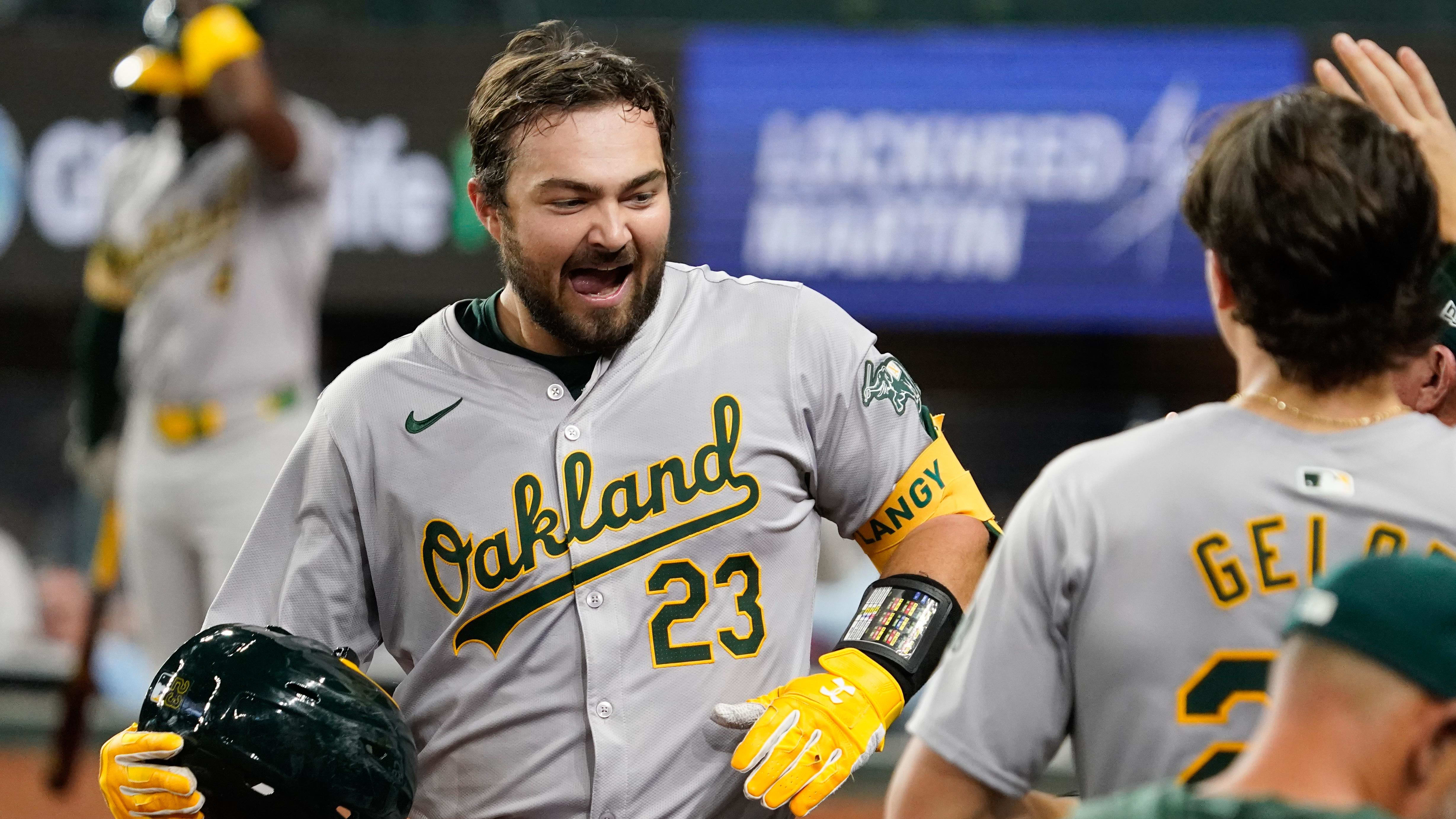 Apr 9, 2024; Arlington, Texas, USA; Oakland Athletics catcher Shea Langeliers (23) is greeted at home plate.