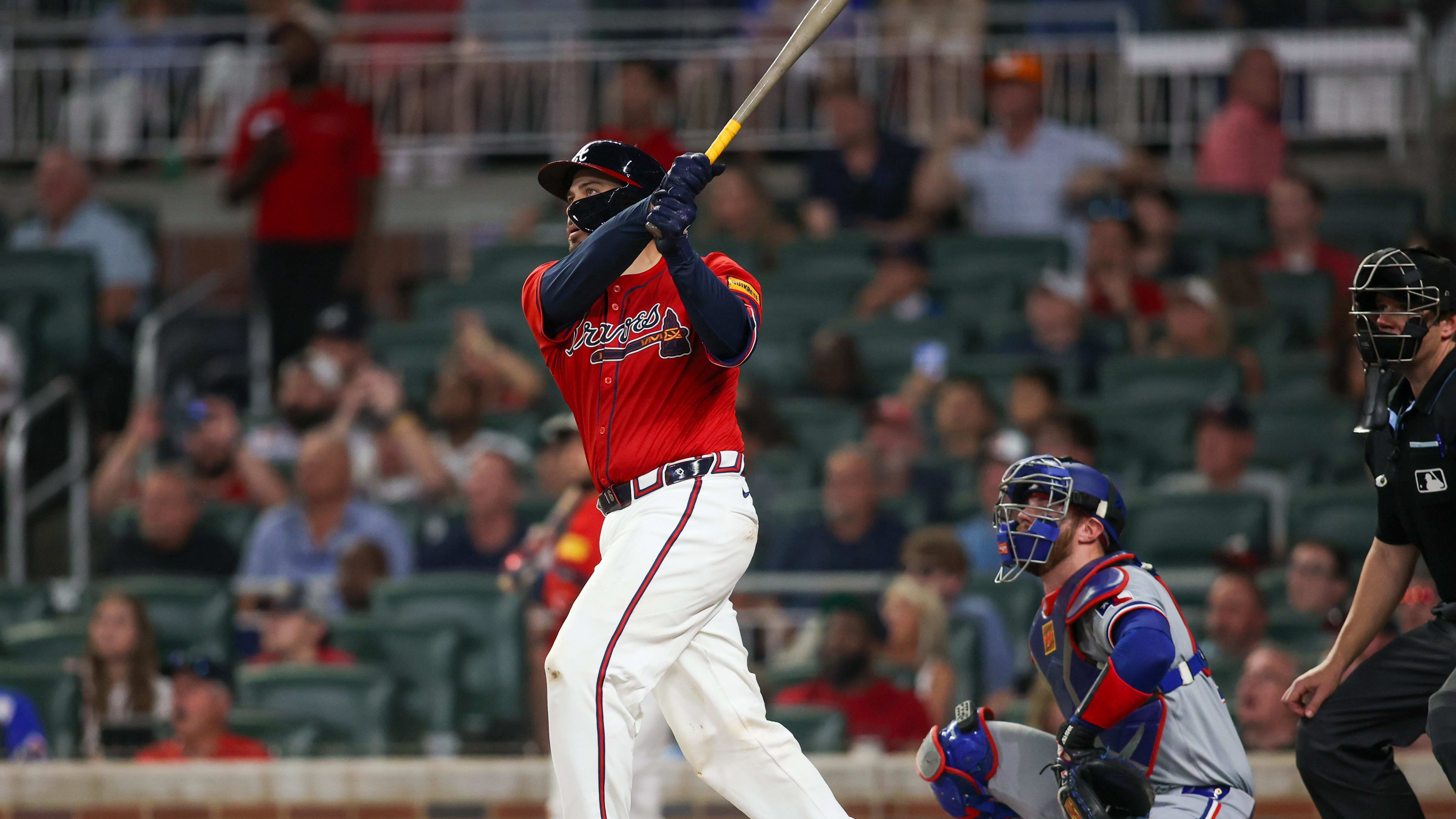 Atlanta Braves catcher Travis d'Arnaud watches his grand slam, his third homer of the night, as the Braves mashed their way past the Texas Rangers from a sold out Truist Park. 