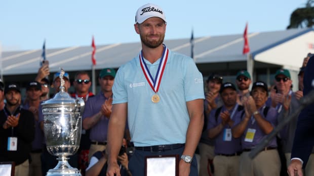 Wyndham Clark celebrates with the championship trophy after winning the U.S. Open golf tournament at Los Angeles Country Club