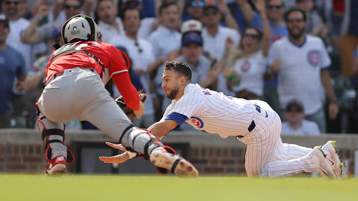 May 31, 2024; Chicago, Illinois, USA; Chicago Cubs third baseman Nick Madrigal (1) slides into home plate as Cincinnati Reds catcher Tyler Stephenson (37) reaches for the tag during the ninth inning at Wrigley Field. Mandatory Credit: Melissa Tamez-USA TODAY Sports