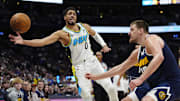 Apr 6, 2025; Denver, Colorado, USA; Indiana Pacers guard Tyrese Haliburton (0) and Denver Nuggets center Nikola Jokic (15) reach for the ball in the second half at Ball Arena. Mandatory Credit: Ron Chenoy-Imagn Images
