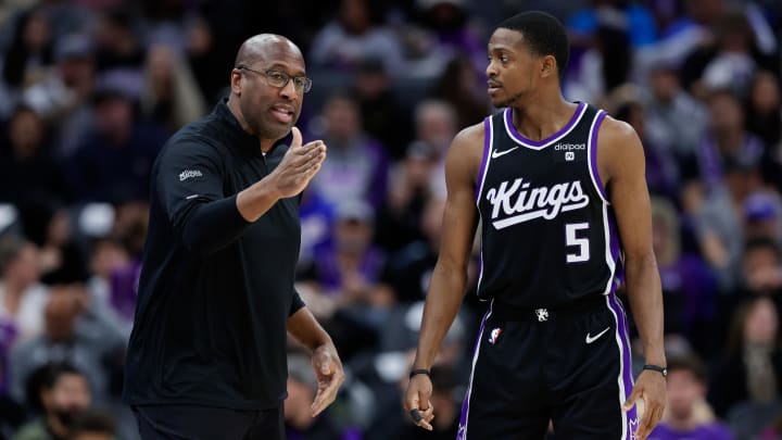 Jan 3, 2024; Sacramento, California, USA; Sacramento Kings head coach Mike Brown talks with guard De'Aaron Fox (5) during the third quarter against the Orlando Magic at Golden 1 Center. Mandatory Credit: Sergio Estrada-USA TODAY Sports