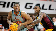 Feb 9, 2025; Stillwater, Oklahoma, USA; Oklahoma State Cowboys forward Abou Ousmane (33) drives to the basket during the first half against the Arizona State Sun Devils at Gallagher-Iba Arena. Mandatory Credit: William Purnell-Imagn Images