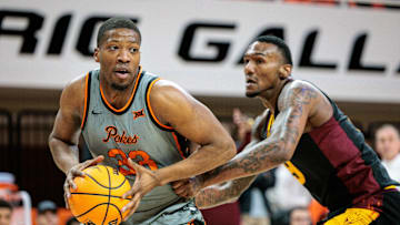 Feb 9, 2025; Stillwater, Oklahoma, USA; Oklahoma State Cowboys forward Abou Ousmane (33) drives to the basket during the first half against the Arizona State Sun Devils at Gallagher-Iba Arena. Mandatory Credit: William Purnell-Imagn Images