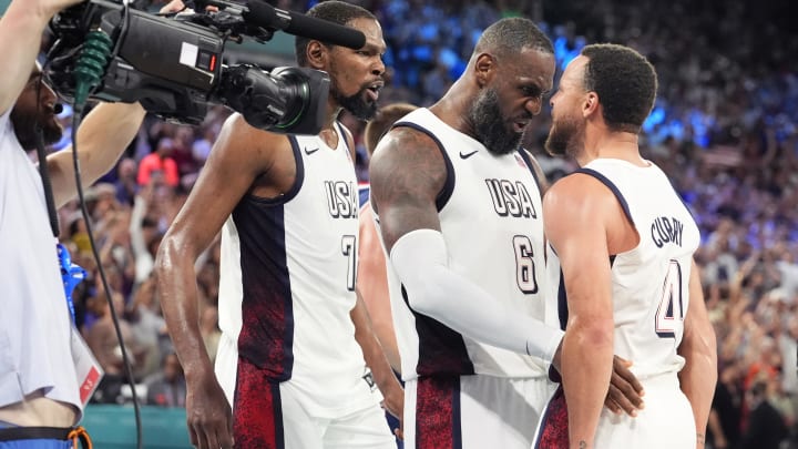 United States guard Kevin Durant (7), guard LeBron James (6) and shooting guard Stephen Curry (4) celebrate after the game against Serbia in a men's basketball semifinal game during the Paris 2024 Olympic Summer Games at Accor Arena. Mandatory Credit: