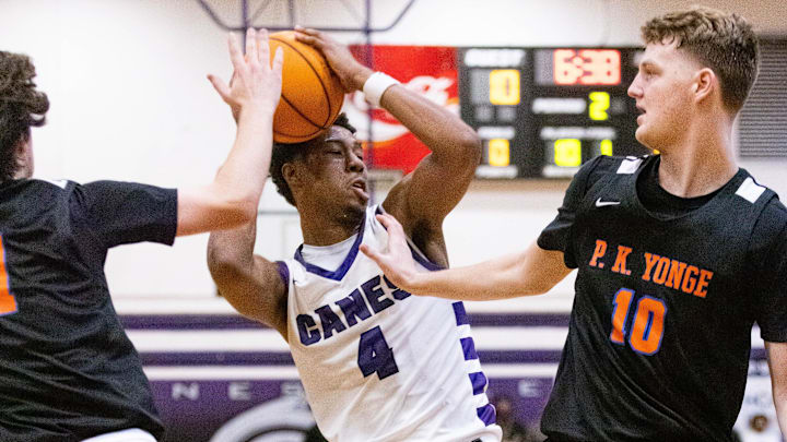 P.K. Yonge Blue Wave guard Simon Childers (1) and P.K. Yonge Blue Wave forward Jack Muller (10) pressures 
Gainesville Hurricanes Cornelius White (4) in the first half. The Gaineville Hurricanes hosted the P.K. Yonge Blue Wave at Citizens Field in Gainesville, FL on Tuesday, November 26, 2024. The Hurricanes defeated the Blue Wave 64-36. [Doug Engle/Ocala Star Banner]