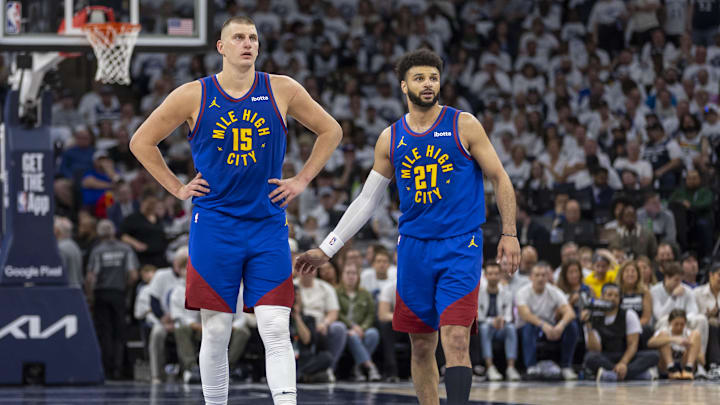 Denver Nuggets center Nikola Jokic (15) and Denver Nuggets guard Jamal Murray (27) against the Minnesota Timberwolves during the second round of the 2024 NBA playoffs at Target Center.