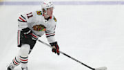 Apr 8, 2025; Pittsburgh, Pennsylvania, USA;  Chicago Blackhawks center Oliver Moore (11) skates with the puck against the Pittsburgh Penguins during the second period at PPG Paints Arena. Mandatory Credit: Charles LeClaire-Imagn Images