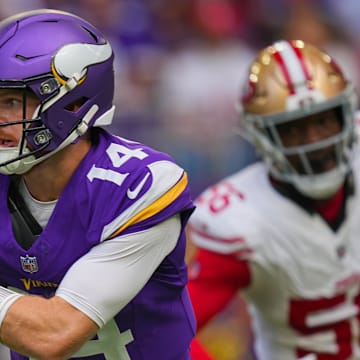 Sep 15, 2024; Minneapolis, Minnesota, USA; Minnesota Vikings quarterback Sam Darnold (14) scrambles against the San Francisco 49ers in the first quarter at U.S. Bank Stadium.