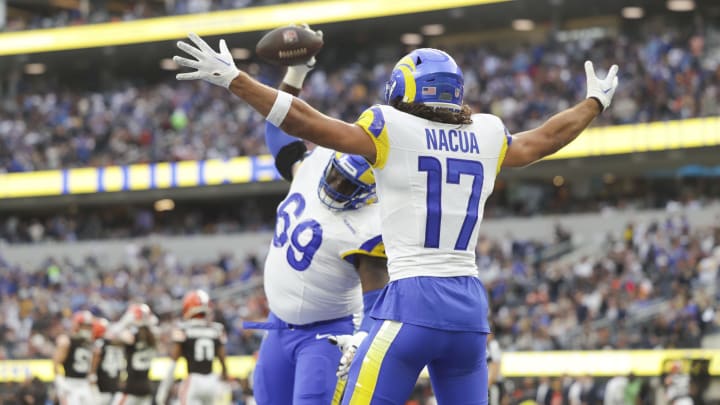 Dec 3, 2023; Inglewood, California, USA; Los Angeles Rams offensive linesmen Kevin Dotson (69) celebrates with Los Angeles Rams wide receiver Puka Nacua (17) after scoring a touchdown in the first half in a game against the Cleveland Browns at SoFi Stadium. Mandatory Credit: Yannick Peterhans-USA TODAY Sports