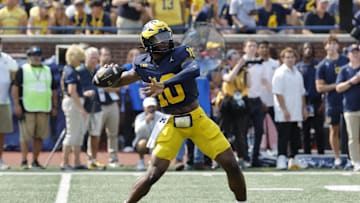 Sep 14, 2024; Ann Arbor, Michigan, USA;  Michigan Wolverines quarterback Alex Orji (10) throws against the Arkansas State Red Wolves during the second half at Michigan Stadium. Mandatory Credit: Rick Osentoski-Imagn Images