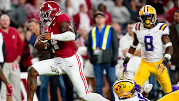 Nov 4, 2023; Tuscaloosa, Alabama, USA; Alabama Crimson Tide quarterback Jalen Milroe (4) scrambles up the field against LSU Tigers defensive end Saivion Jones (35) during the second half at Bryant-Denny Stadium. Alabama Crimson Tide defeated the LSU Tigers 42-28. Mandatory Credit: John David Mercer-Imagn Images