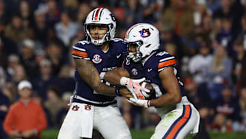 Nov 1, 2025; Auburn, Alabama, USA;  Auburn Tigers quarterback Ashton Daniels (12) hands off to running back Jeremiah Cobb (23) during the first quarter against the Kentucky Wildcats at Jordan-Hare Stadium. Mandatory Credit: John Reed-Imagn Images