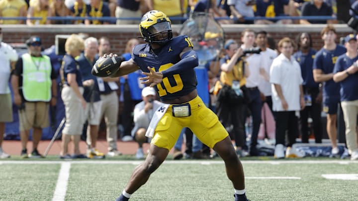 Sep 14, 2024; Ann Arbor, Michigan, USA;  Michigan Wolverines quarterback Alex Orji (10) throws against the Arkansas State Red Wolves during the second half at Michigan Stadium. Mandatory Credit: Rick Osentoski-Imagn Images