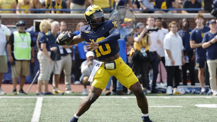 Sep 14, 2024; Ann Arbor, Michigan, USA;  Michigan Wolverines quarterback Alex Orji (10) throws against the Arkansas State Red Wolves during the second half at Michigan Stadium. Mandatory Credit: Rick Osentoski-Imagn Images