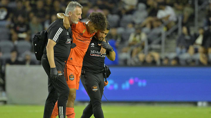 Aug 31, 2024; Los Angeles, California, USA; Houston Dynamo FC forward Lawrence Ennali (37) is helped off the field after an apparent injury against LAFC in the second half at BMO Stadium. Mandatory Credit: Jayne Kamin-Oncea-Imagn Images