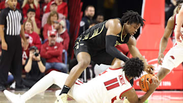 Dec 30, 2024; Fayetteville, Arkansas, USA; Arkansas Razorbacks forward Karter Knox (11) and Oakland Golden Grizzlies forward Allen Mukeba (23) reach for a loose ball in the first half at Bud Walton Arena. Mandatory Credit: Nelson Chenault-Imagn Images